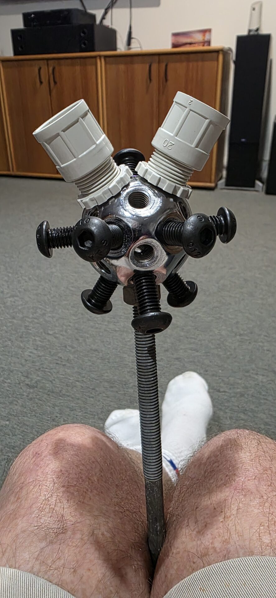 Close-up of one sphere hub, showing the M10 screws and conduit adaptors at the 12 meteor-stick positions